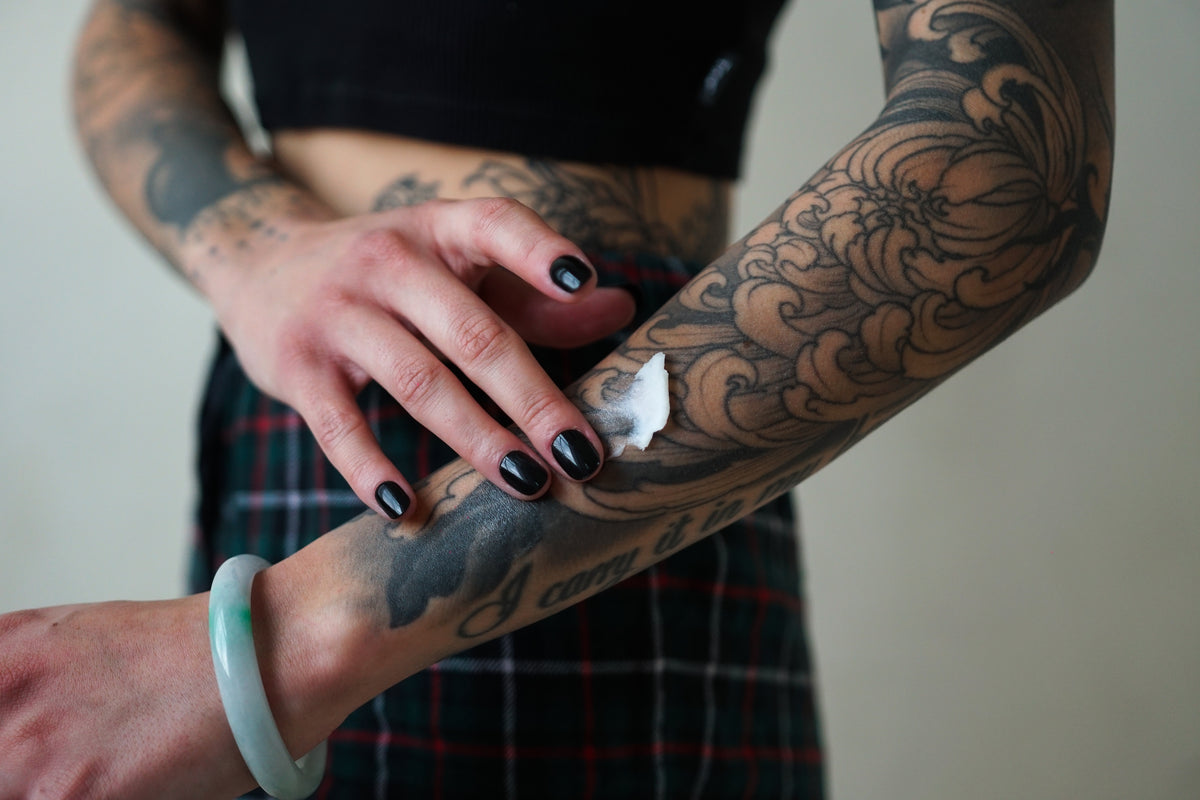 A close-up of a tattooed forearm showcasing the initial vibrancy of the tattoo.